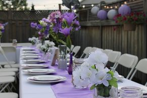 A table set with plates and flowers on it.