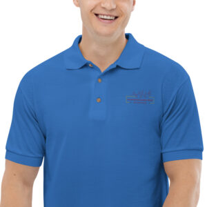 A man wearing a blue polo shirt and smiling.