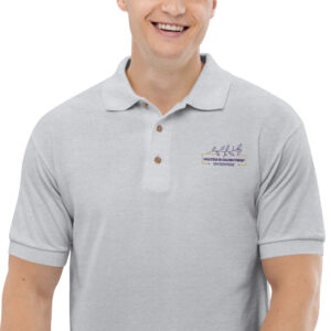 A man wearing a polo shirt with the words " not to be missed ".