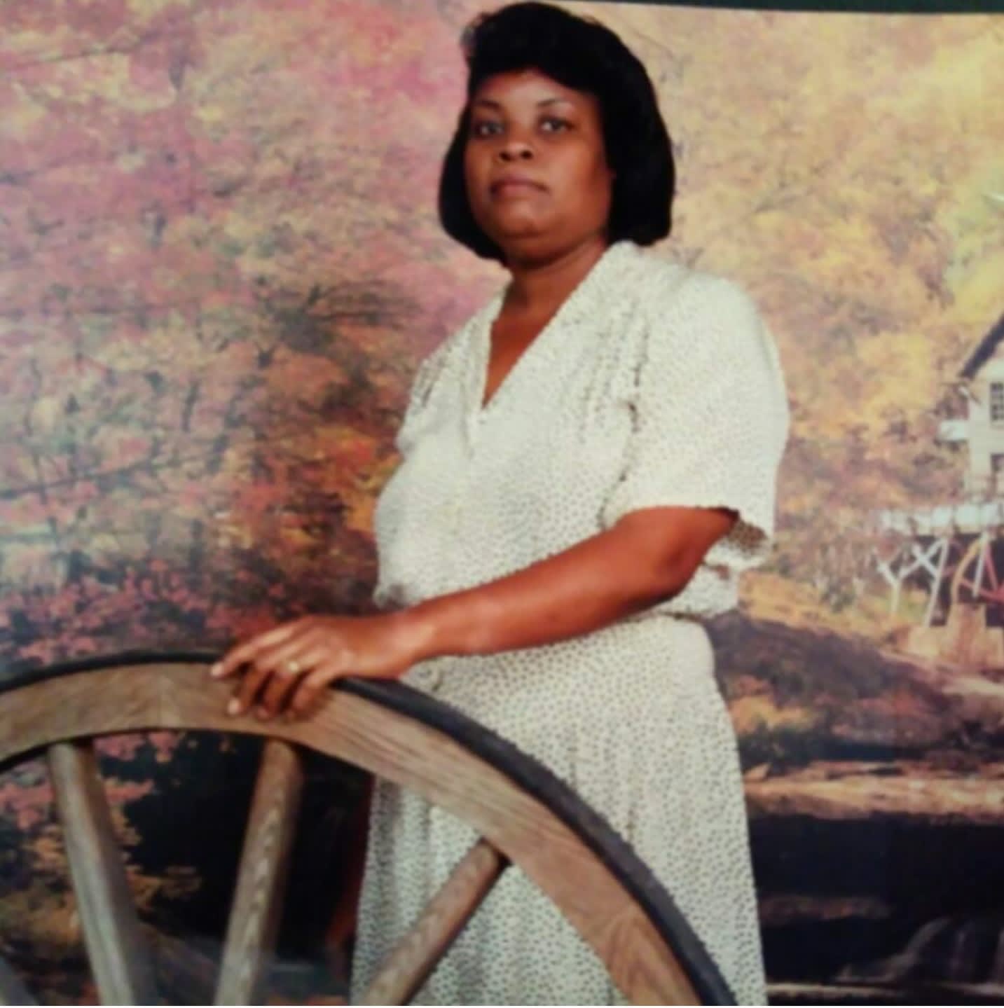 A picture of a woman posing with a wheel