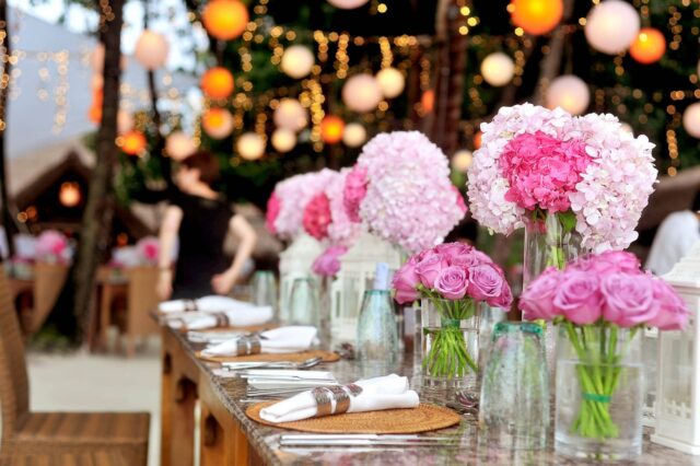 A table with plates and flowers on it