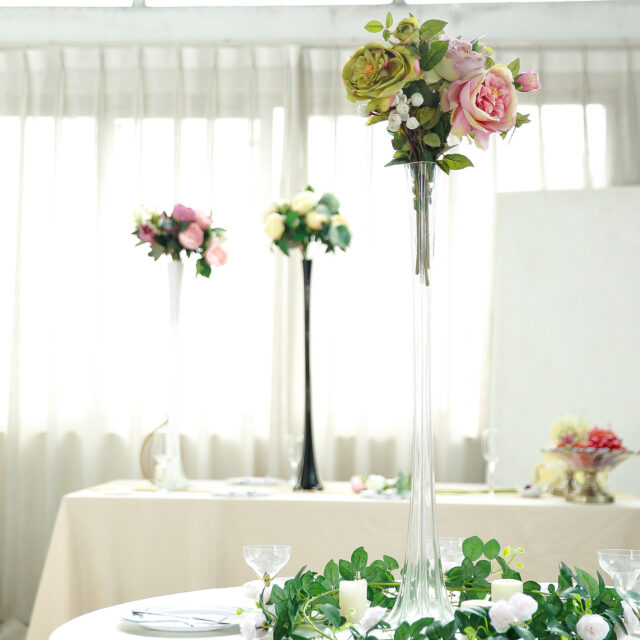 A table with flowers and glasses on it